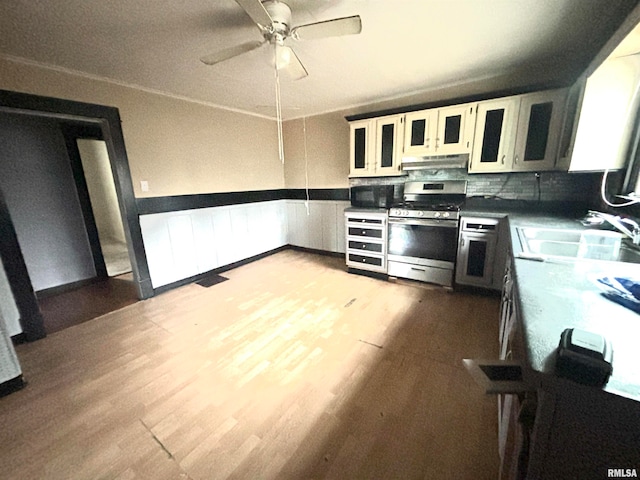 kitchen featuring light wood-type flooring, white cabinetry, sink, and stainless steel gas range