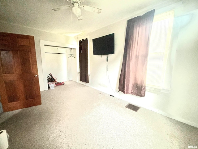 bedroom with ceiling fan and a closet