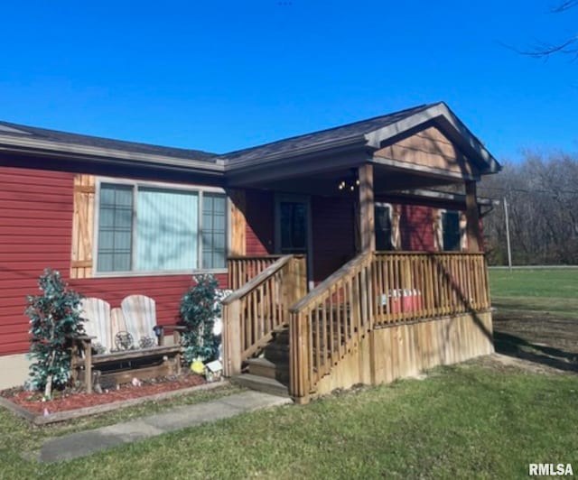 view of front facade with a front yard and a porch