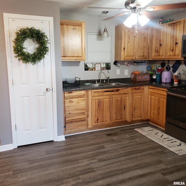 kitchen with dark hardwood / wood-style flooring, black electric range, pendant lighting, and sink