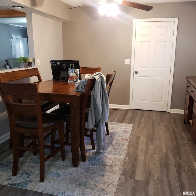 dining area with dark hardwood / wood-style flooring and ceiling fan