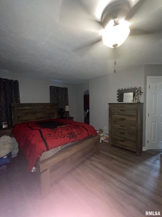 bedroom featuring hardwood / wood-style floors and a textured ceiling