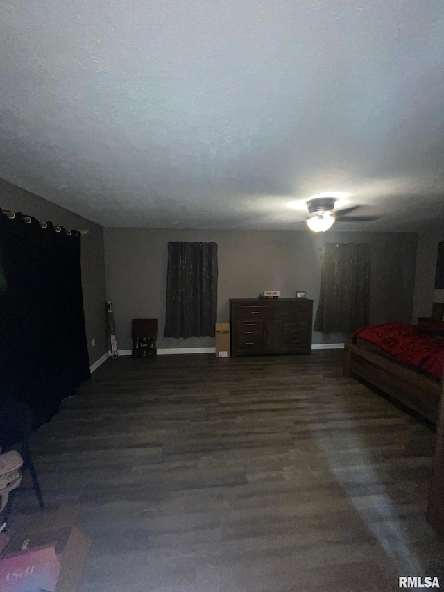 bedroom featuring ceiling fan and dark wood-type flooring