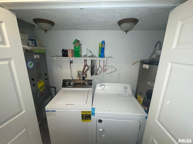 laundry room with washing machine and clothes dryer and water heater