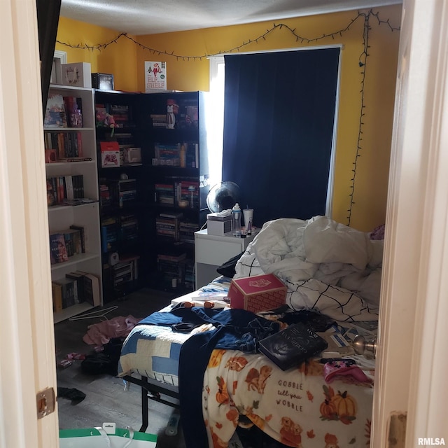 bedroom with hardwood / wood-style flooring