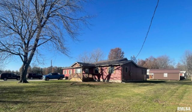 view of side of property with a lawn