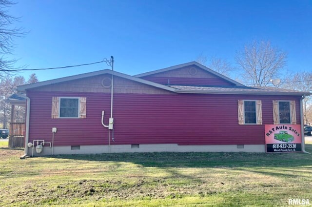 view of side of home featuring a lawn