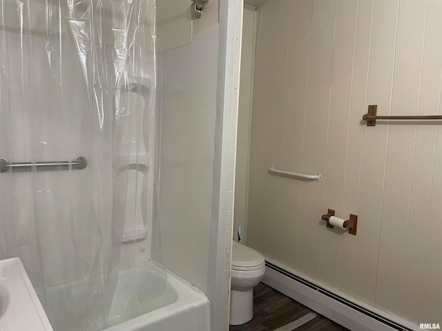 bathroom featuring hardwood / wood-style flooring, toilet, shower / bathtub combination with curtain, and a baseboard heating unit