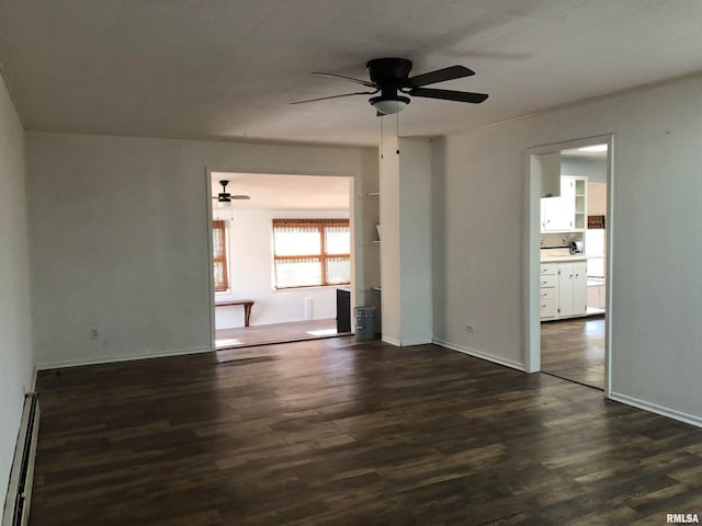 unfurnished room with dark hardwood / wood-style flooring, ceiling fan, and a baseboard heating unit