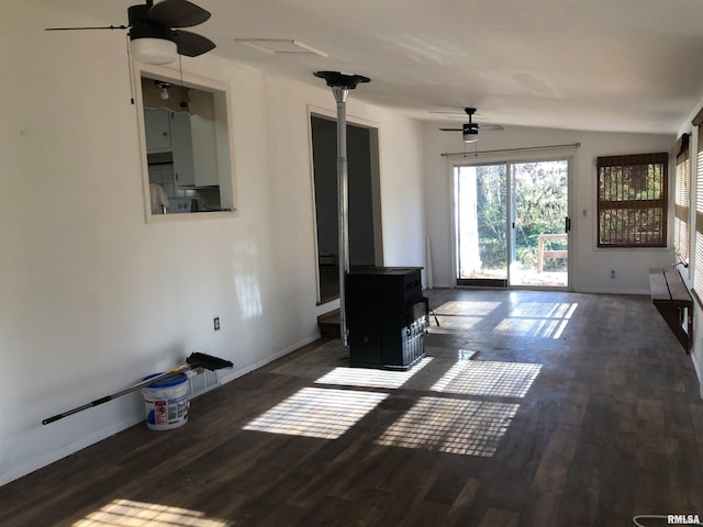 unfurnished living room with a wood stove, ceiling fan, dark wood-type flooring, and lofted ceiling