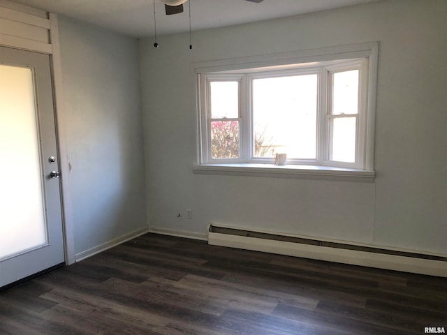 unfurnished room with ceiling fan, dark wood-type flooring, and a baseboard radiator