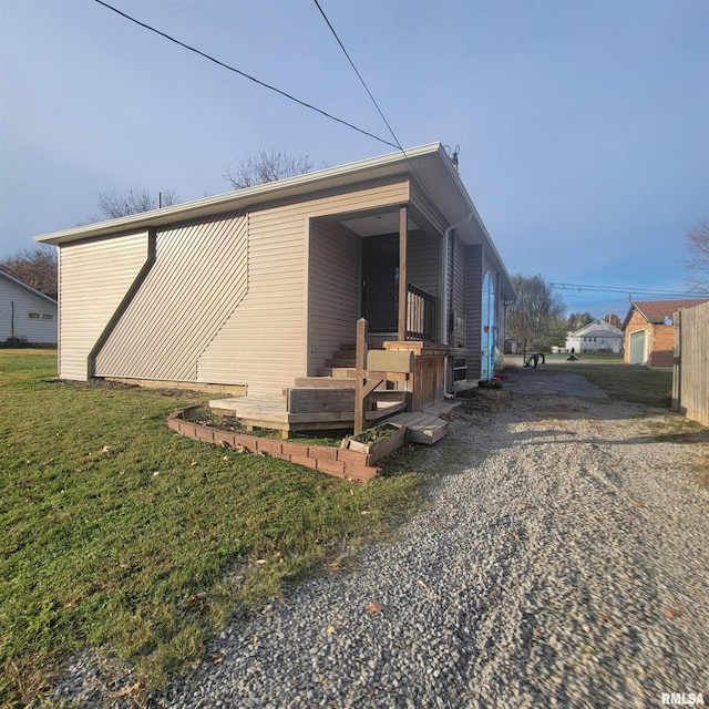 view of side of home featuring a yard