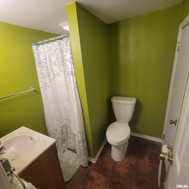 bathroom with tile patterned flooring, vanity, and toilet