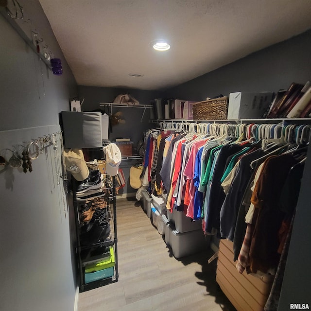 walk in closet featuring light hardwood / wood-style flooring