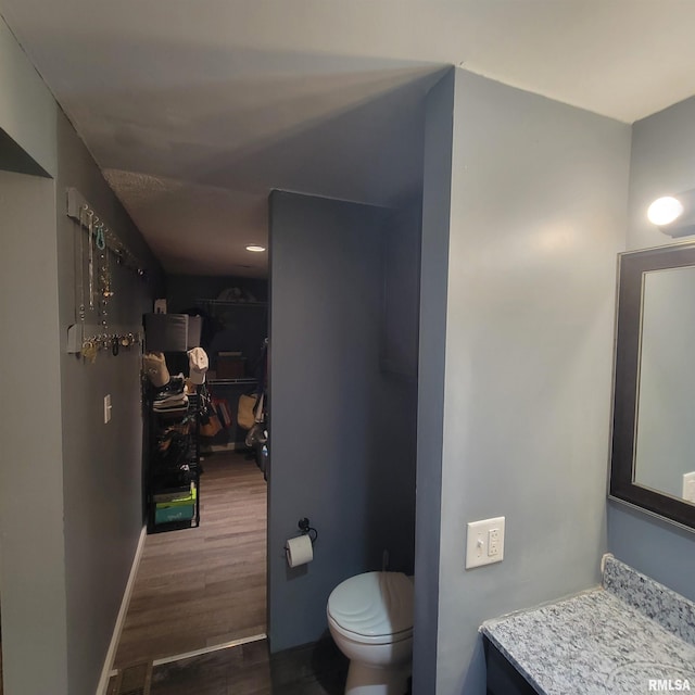 bathroom with hardwood / wood-style floors and toilet