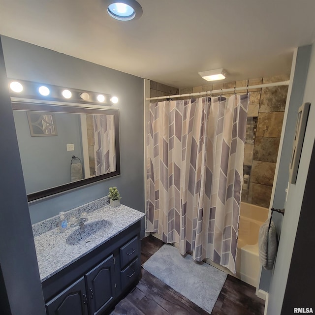 bathroom featuring wood-type flooring, vanity, and shower / bath combo with shower curtain