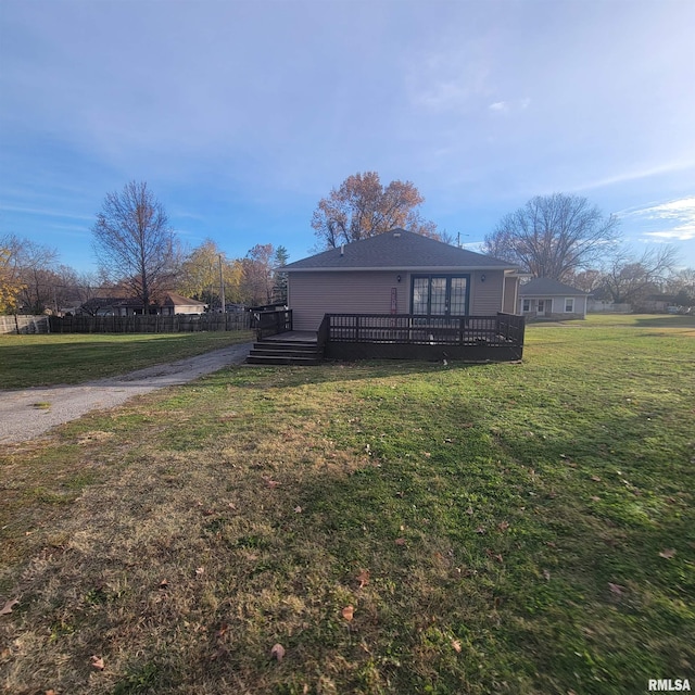 exterior space with a wooden deck and a front lawn