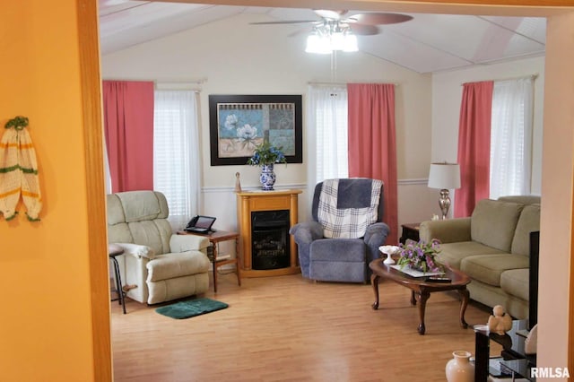 living room featuring hardwood / wood-style flooring, ceiling fan, and lofted ceiling