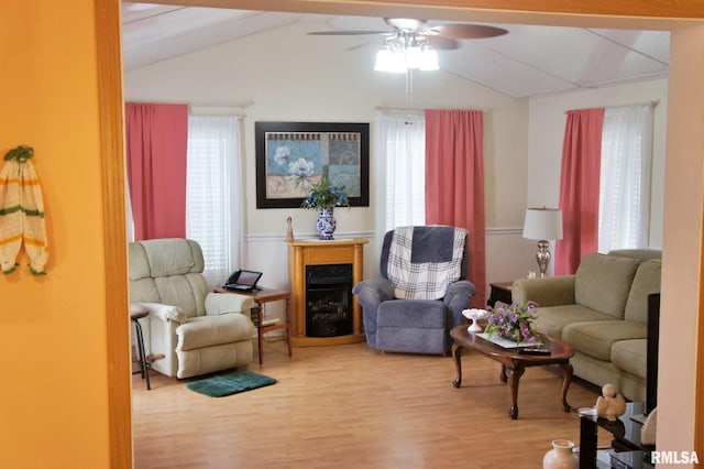 sitting room with lofted ceiling with beams, hardwood / wood-style flooring, and ceiling fan