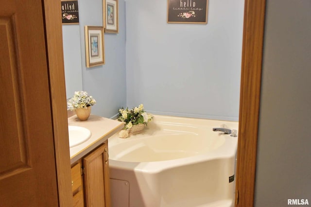 bathroom featuring a tub to relax in and vanity