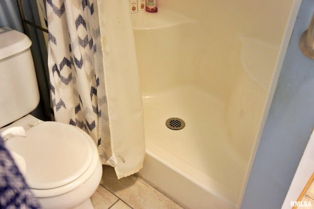 bathroom featuring tile patterned flooring and toilet