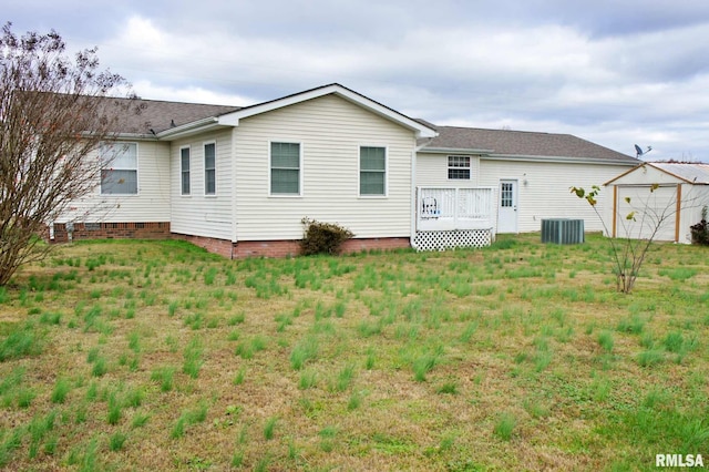 back of house with a yard, central AC, and a wooden deck