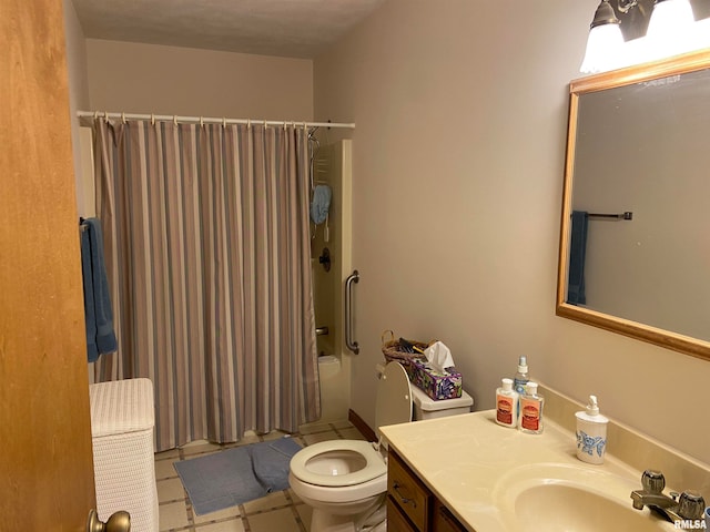 bathroom featuring tile patterned floors, vanity, a textured ceiling, and toilet