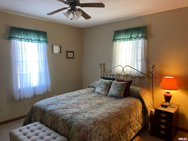 bedroom with carpet, multiple windows, and ceiling fan