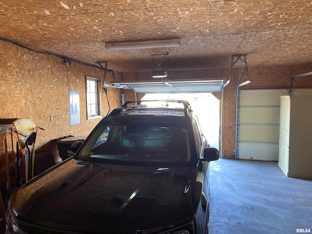 garage featuring electric panel and a garage door opener