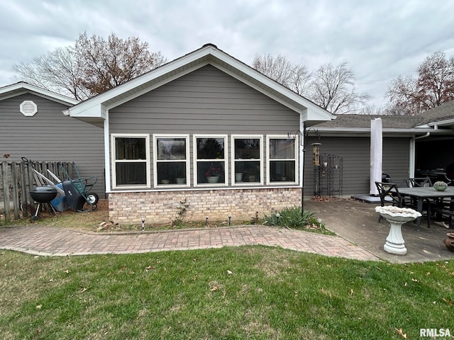 rear view of house with a yard and a patio area