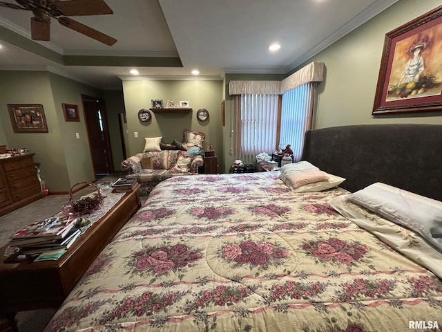 carpeted bedroom with ceiling fan, a raised ceiling, and crown molding