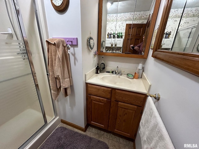 bathroom featuring vanity and a shower with shower door