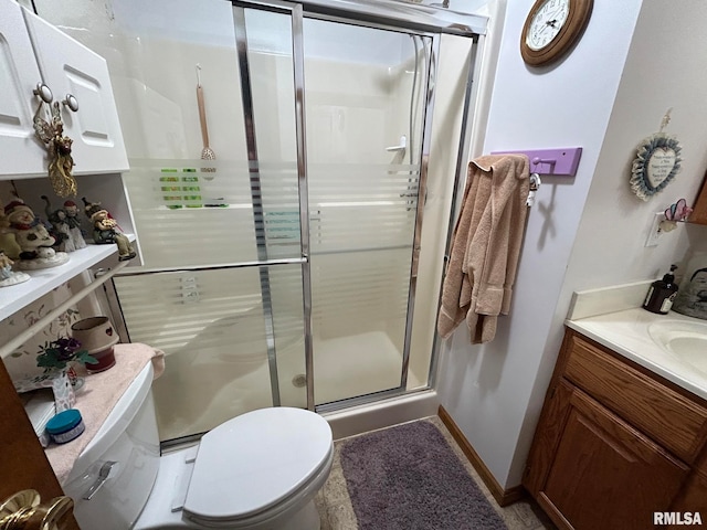 bathroom featuring vanity, toilet, and walk in shower