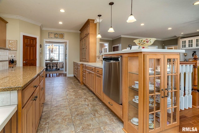 kitchen with light stone countertops, a center island, decorative light fixtures, and ornamental molding