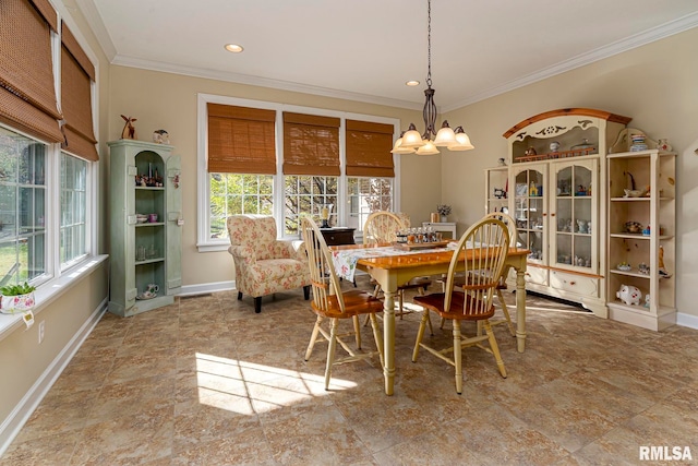 dining room with ornamental molding and a notable chandelier