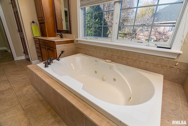 bathroom with vanity, tile patterned floors, plenty of natural light, and tiled tub