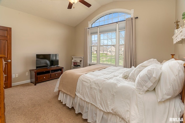 carpeted bedroom with vaulted ceiling, multiple windows, and ceiling fan