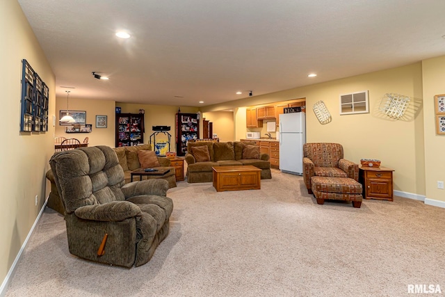 carpeted living room with sink