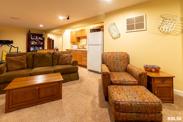 living room featuring sink and light colored carpet