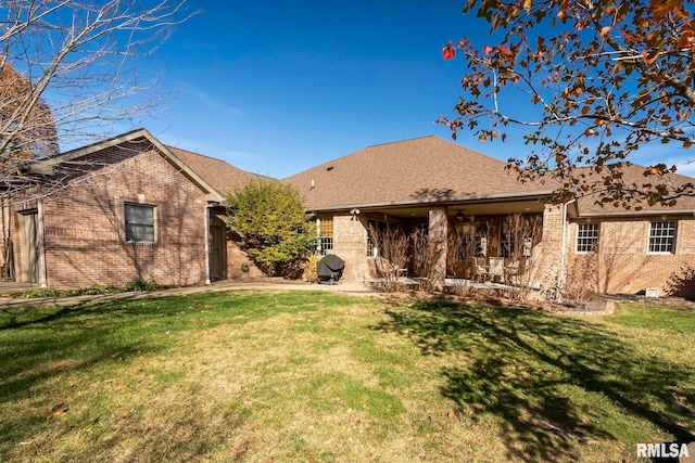 rear view of house featuring a lawn