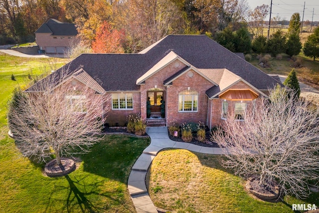 view of front of property with a front yard and french doors