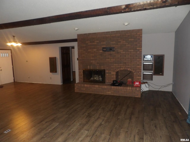 unfurnished living room featuring beam ceiling, a brick fireplace, and wood-type flooring