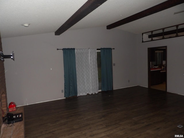 spare room featuring vaulted ceiling with beams and dark hardwood / wood-style flooring