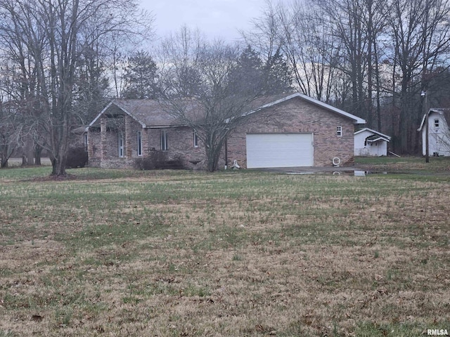 ranch-style home with a front yard and a garage