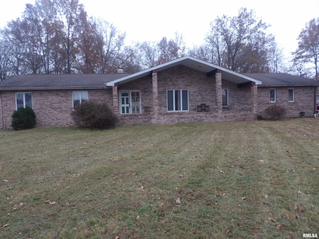 rear view of property with a lawn