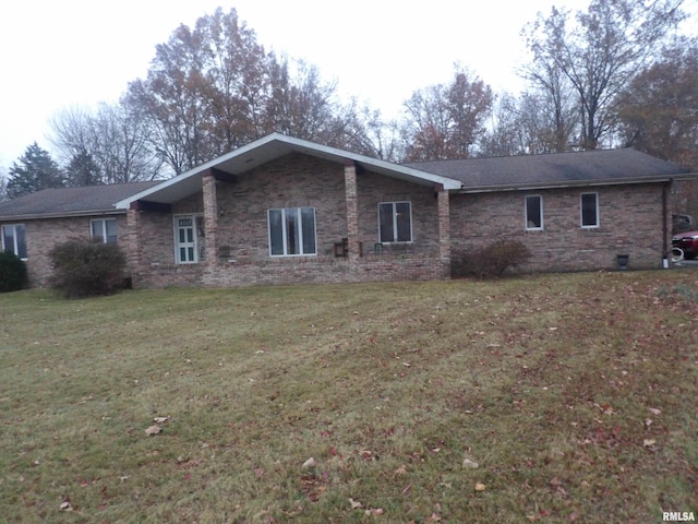 rear view of house featuring a lawn