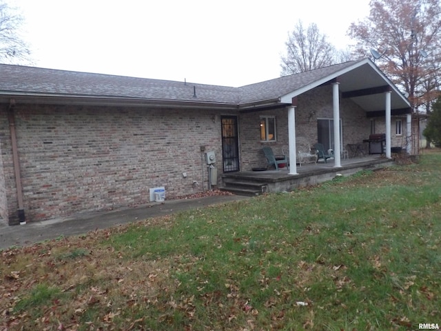 rear view of house featuring a yard