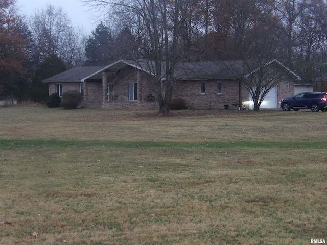 ranch-style house featuring a garage and a front yard