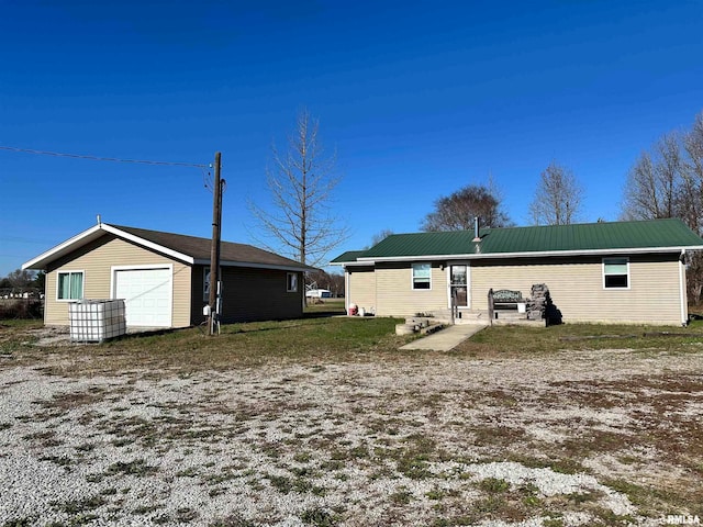 back of property with a garage