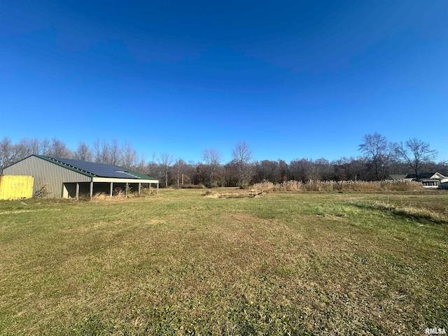 view of yard with an outbuilding and a rural view